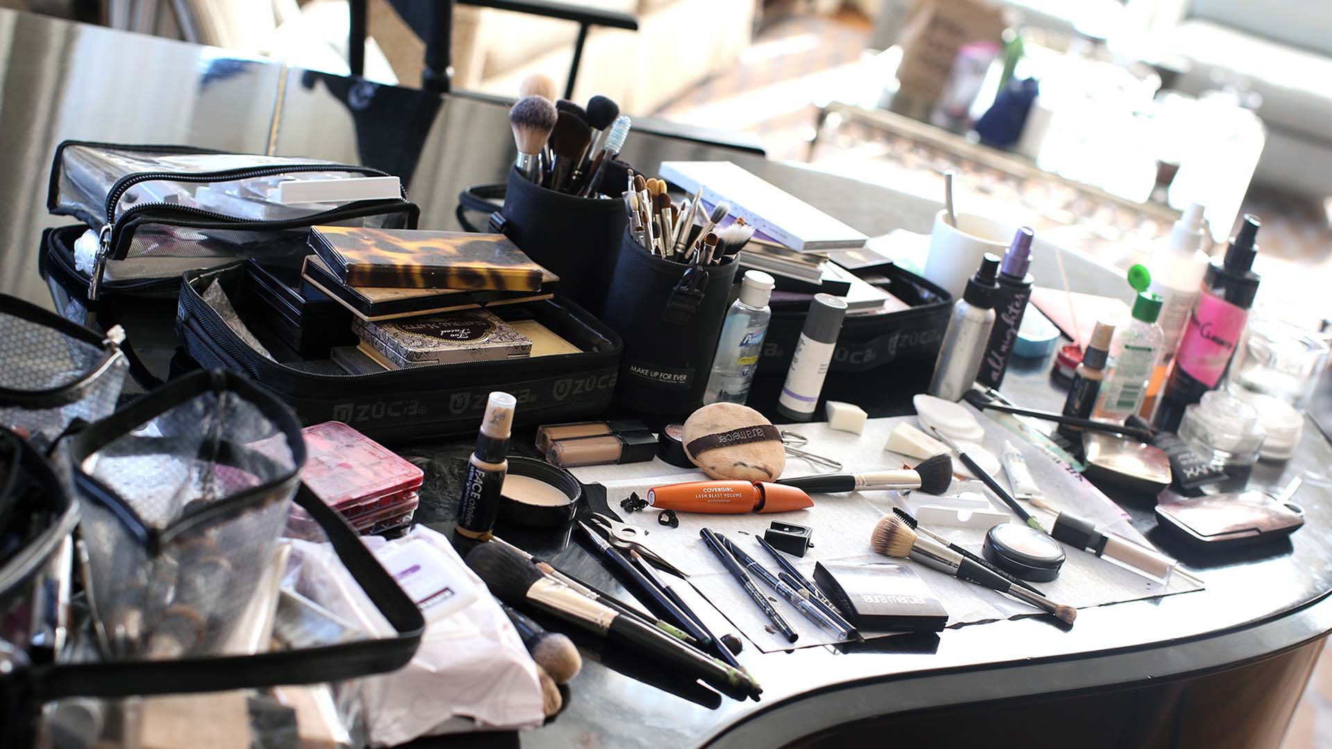 Makeup artist working with a client on location